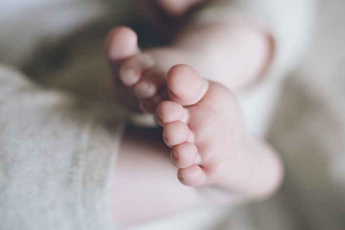 Charming cute baby feet and fingers of new born