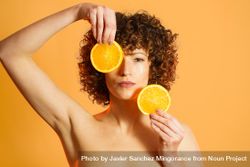 Woman in orange studio with orange slices 4BKPdb