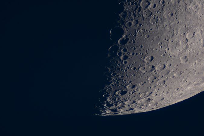 Close-up of lunar surface showing numerous prominent moon craters.