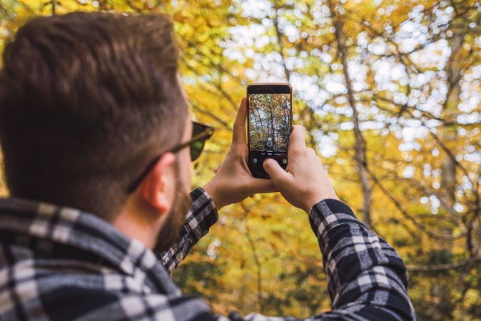 Casual tourist making photo on smartphone of nature