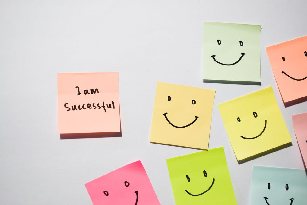 I am successful and smile emoticon on sticky notes