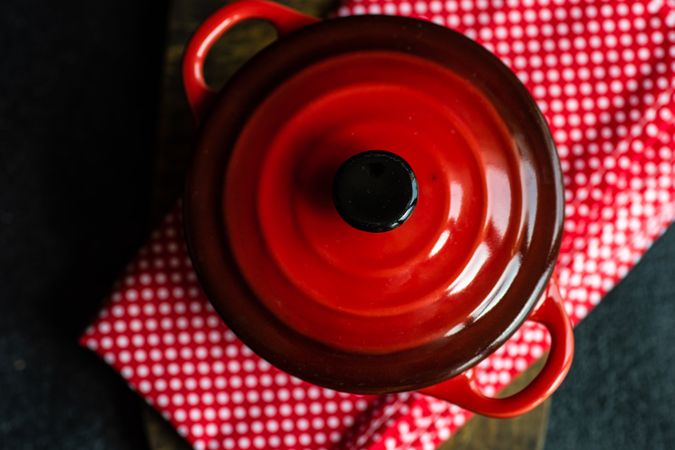 Top view of red cast iron pan on kitchen towel