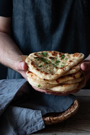 Crop man demonstrating naan bread