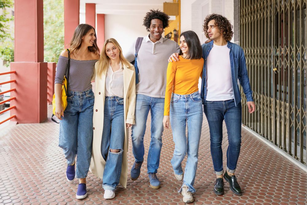 Group of friends walking down street outside
