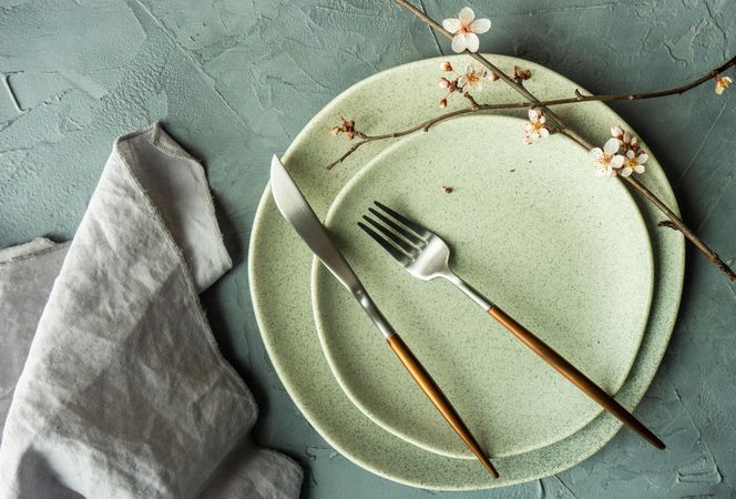 Spring table setting with delicate cherry blossom tree branch