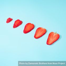 Slices of strawberries on blue background bGWgxb