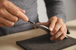 Man taking screw driving to smartphone