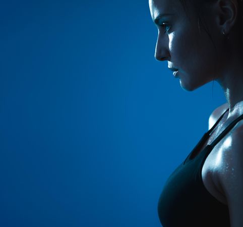 Close up of determined woman wearing dark sports bra