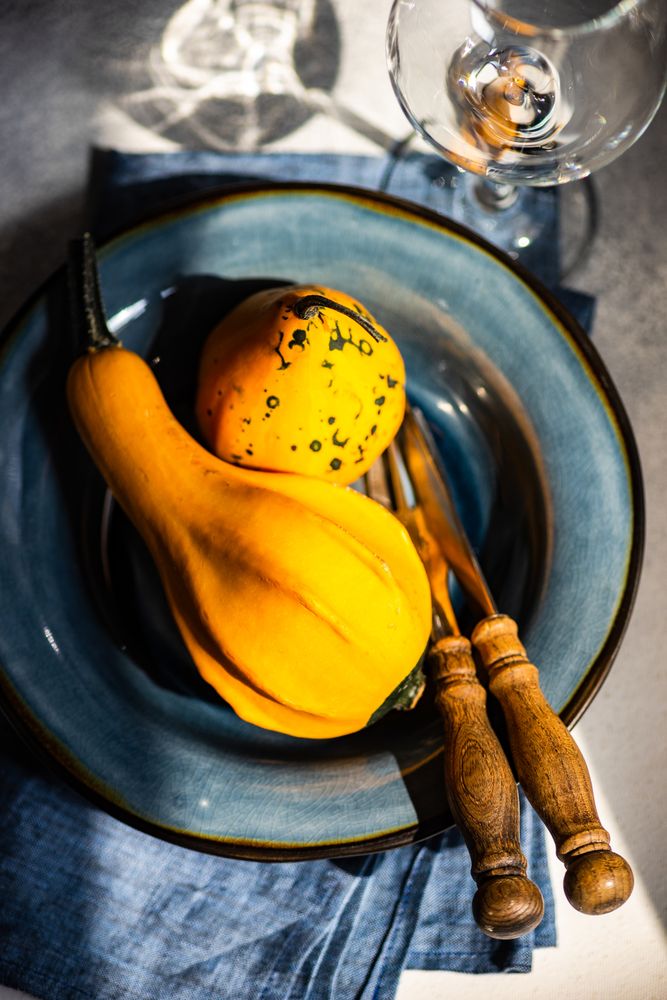 Top view of fall squashes on blue tableware