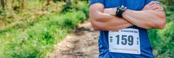 Male trail athlete posing with race number