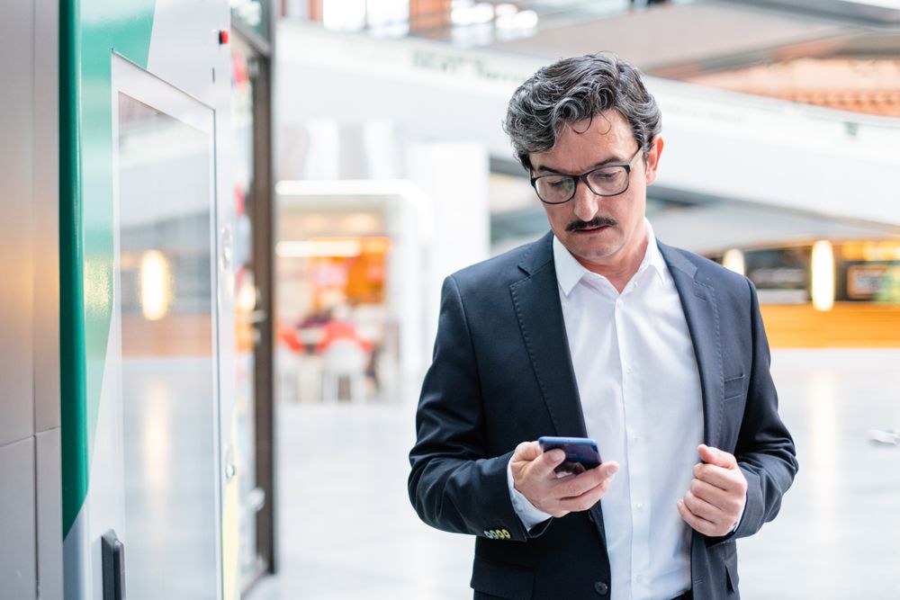 Puzzled businessman in stylish formal wear at shopping plaza