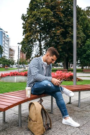Young male using tablet outdoors