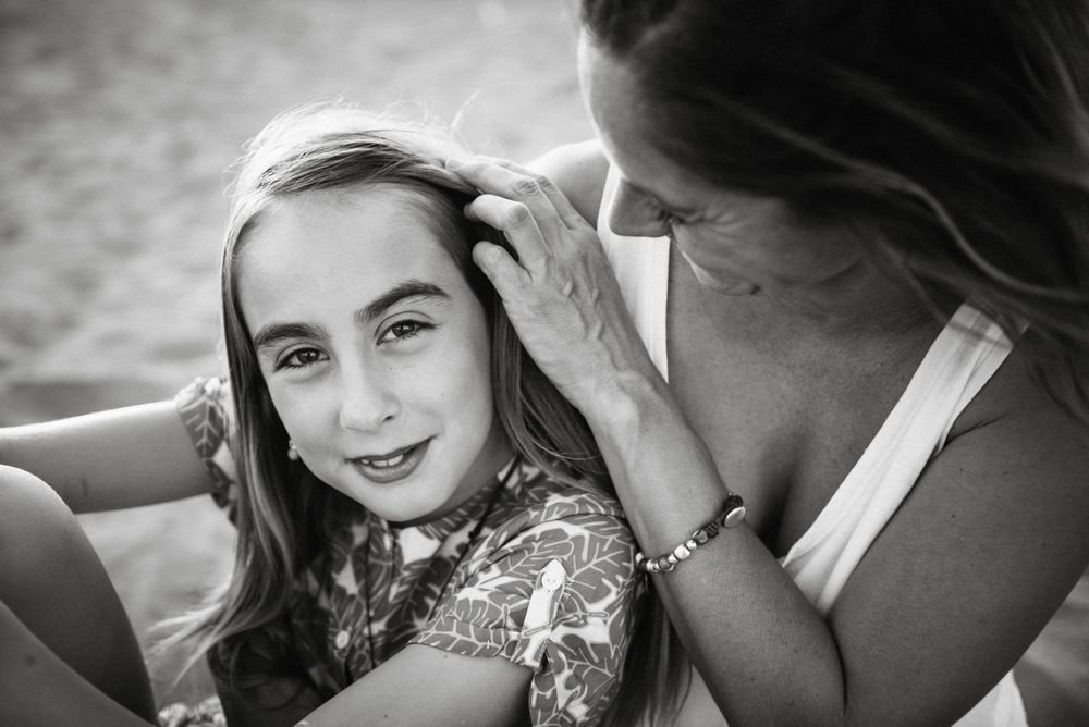Woman with daughter on sunny beach