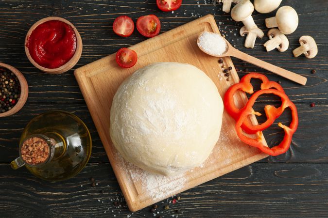 Ingredients for cooking pizza on wooden background