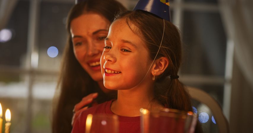 Happy Excited Girl Blowing Out Candles on Her Delicious Birthday Cake.