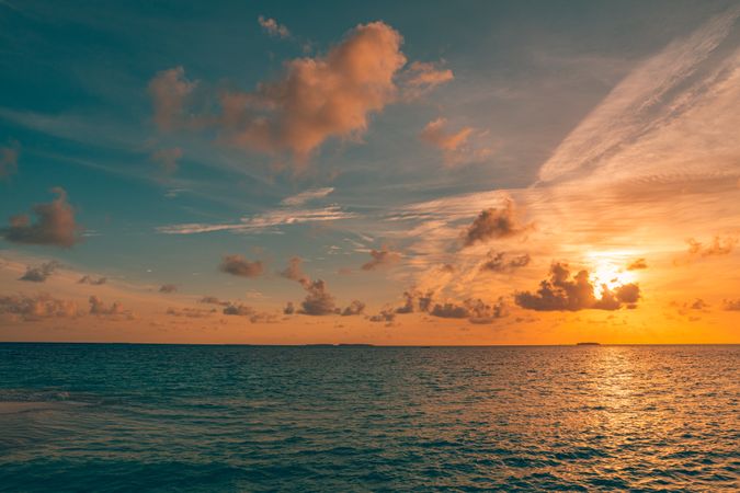 Orange and blue sky at dusk over the ocean