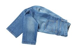 Close-up of folded jeans, isolated on light background