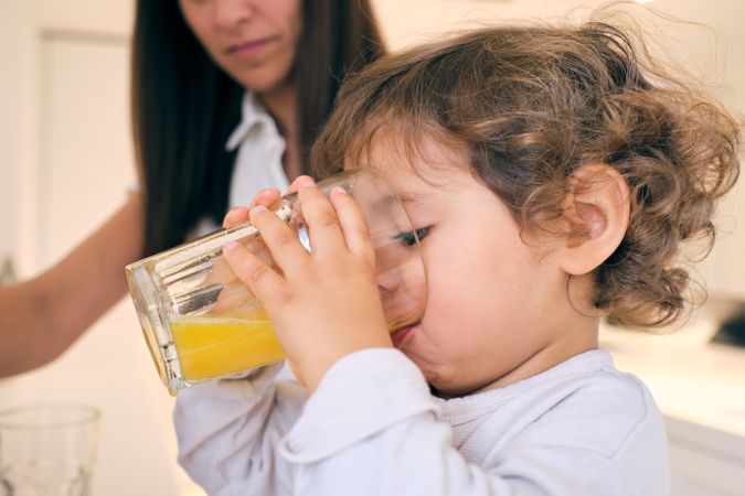Little boy drinking orange juice