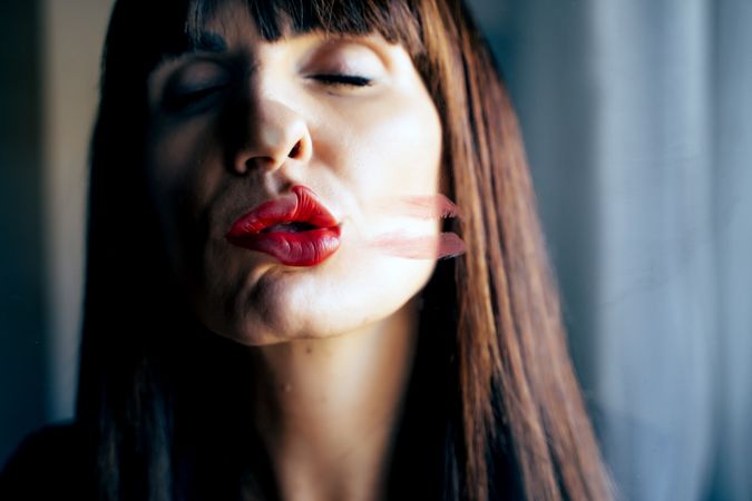 Stylish woman kissing glass