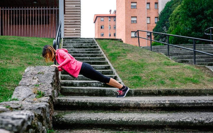 Female athlete doing push-ups outdoors