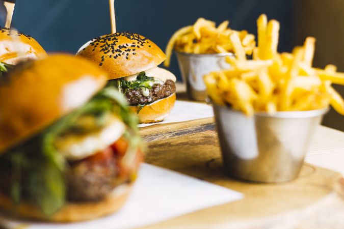 Juicy delicious burger and fried potato on table