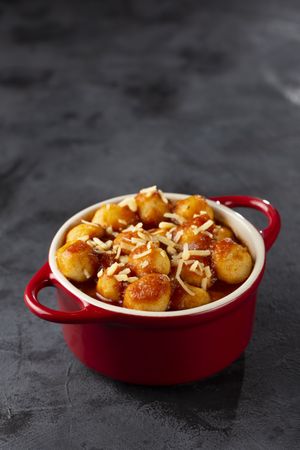Gnocchi with tomato sauce and grated Parmesan cheese.