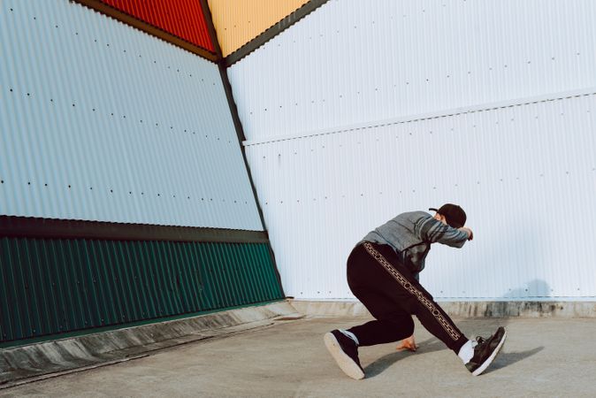 Man performing handstand near wall