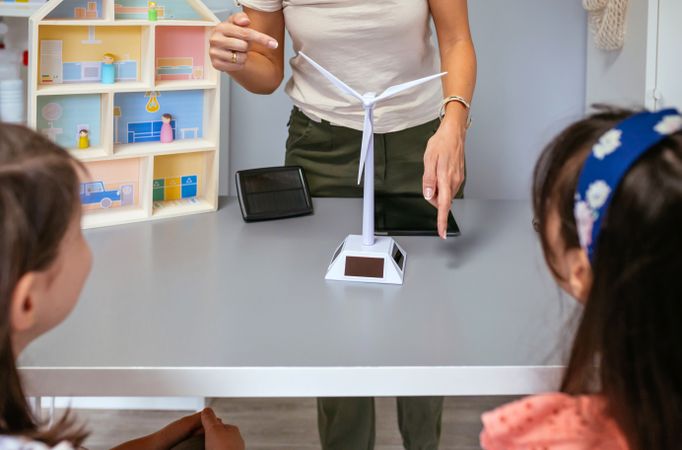 Teacher showing windmill to her students in ecology classroom