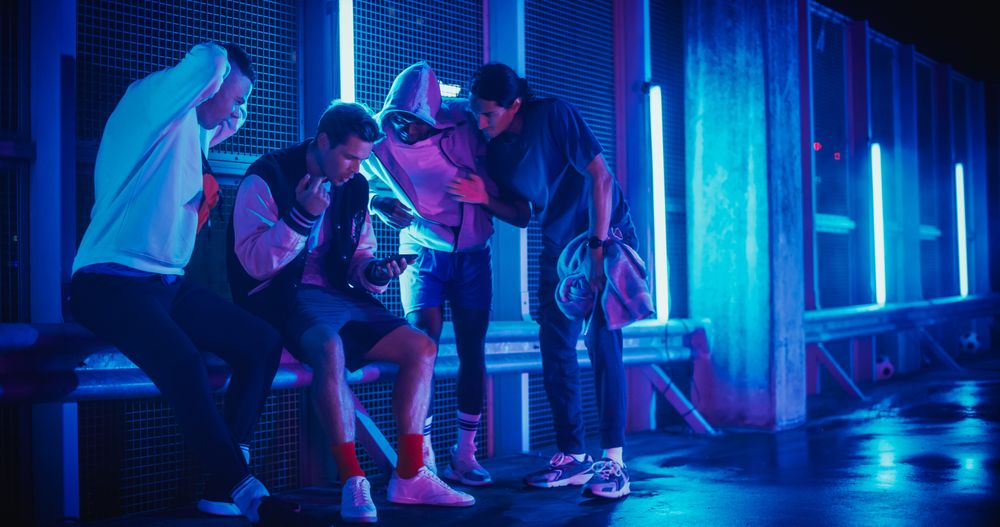 Group of Young Diverse Men Watching a Sports Game on Smartphone Device