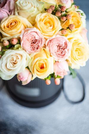 Top view of yellow and pink roses on concrete background