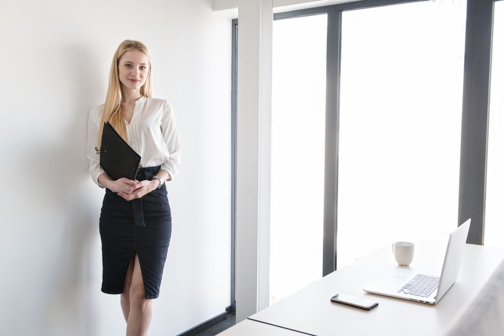 Smiling woman using tablet in office