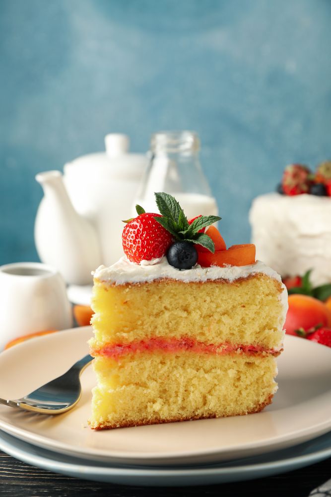Composition with delicious berry cream cake on wooden table. Tasty dessert