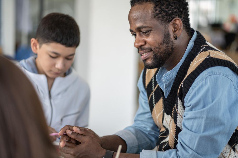 Male teacher with students in classroom