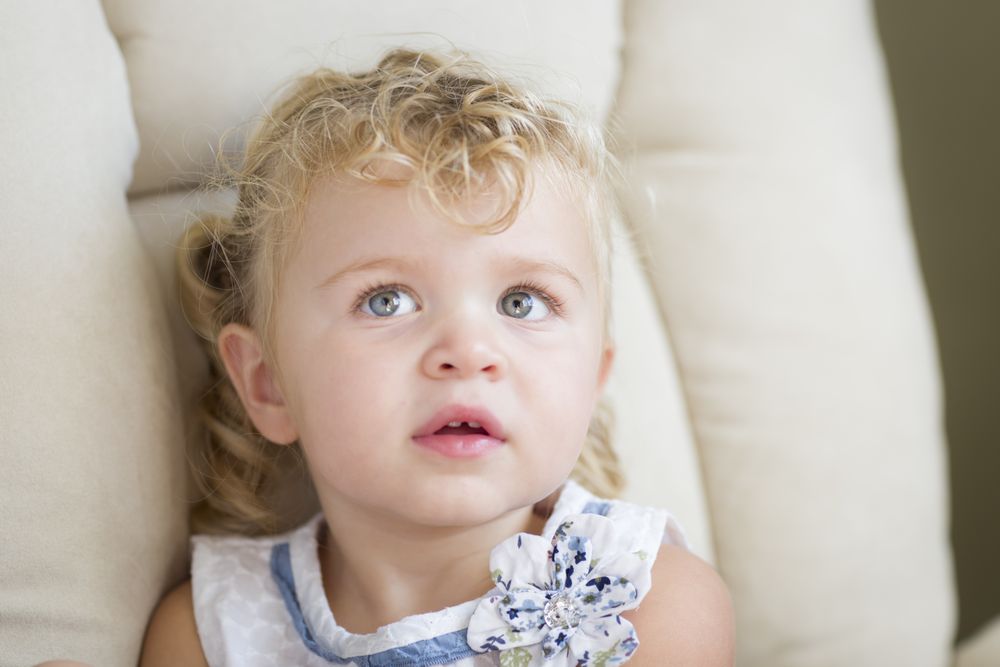 Sweet Blonde and Blue Eyed Little Girl in Chair