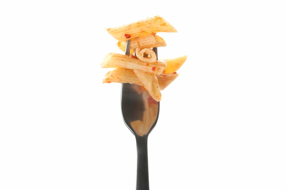 Fork with tasty pasta isolated on blank background