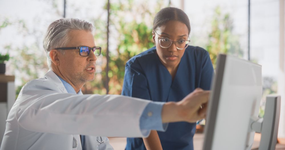 Black Female Surgeon Chatting with Male Physical