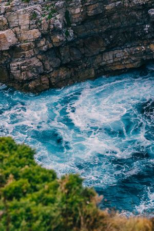 Sea waves crashing near cliff