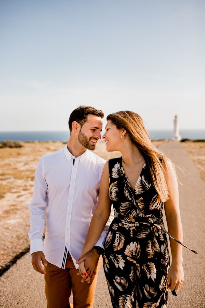 Happy lovers walking on path from sea