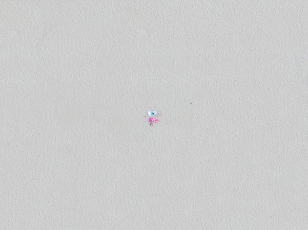 Top down view of friends relaxing on the beach.