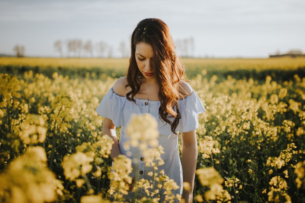 Woman with flowers in field