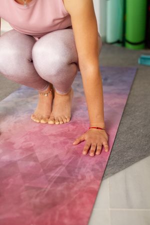 Woman in sitting pose on yoga mat