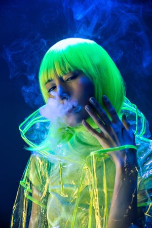 Asian woman smoking in fluorescent light