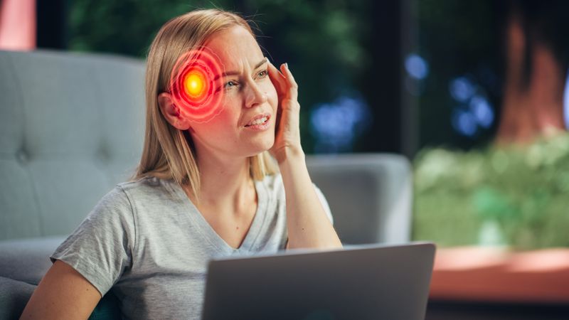 VFX Headache Render: Close Up of a Female Working on Laptop Computer and Experiencing Discomfort and Migraine.