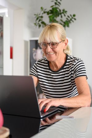 Cheerful woman working on laptop