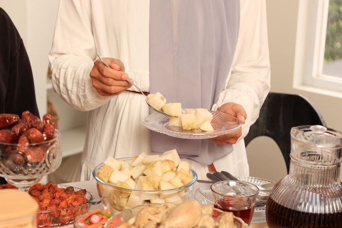 Female Hand Holding Plate with Diced Ketupat Lebaran,