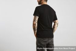 Rearview of bearded man in plain dark t-shirt and dark jeans bxGoj4