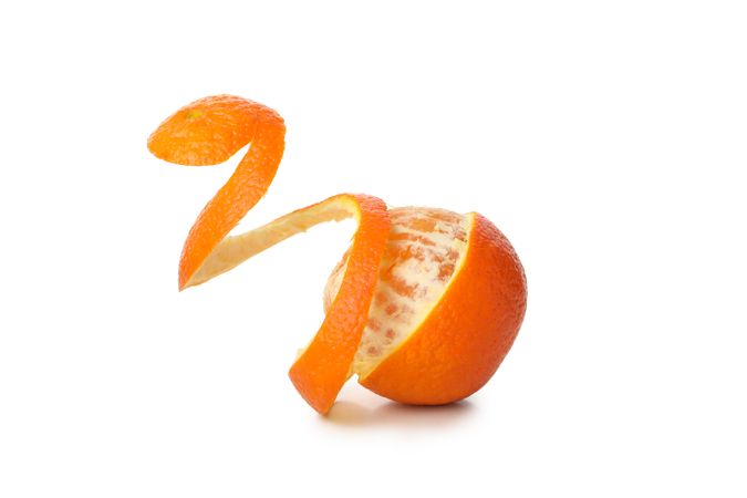 Mandarin with spiral peel isolated on light background