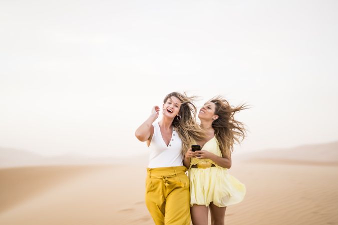 Happy women walking in the desert in desert