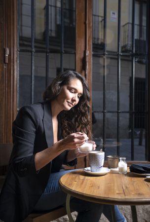 Young female with tea cup in cafe