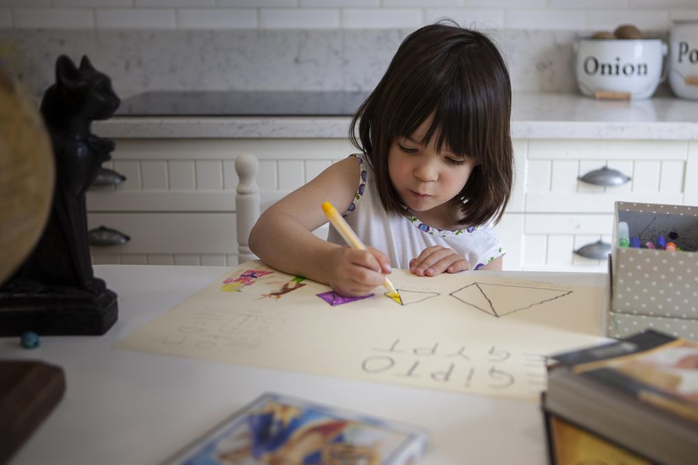 Young girl drawing at home